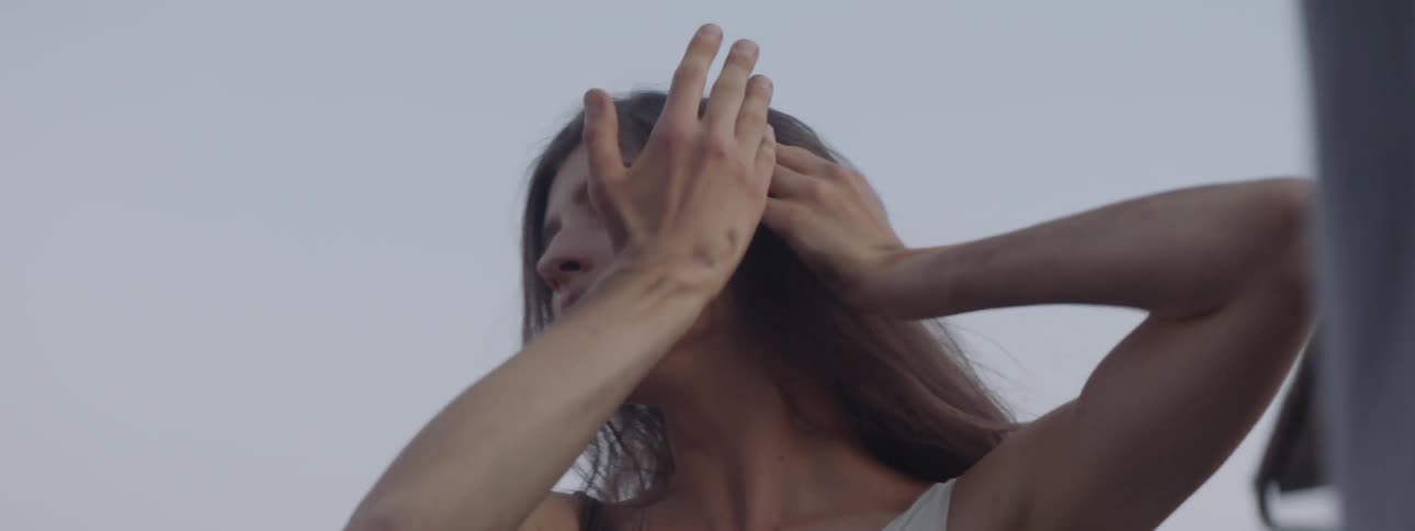 A young woman dances outside