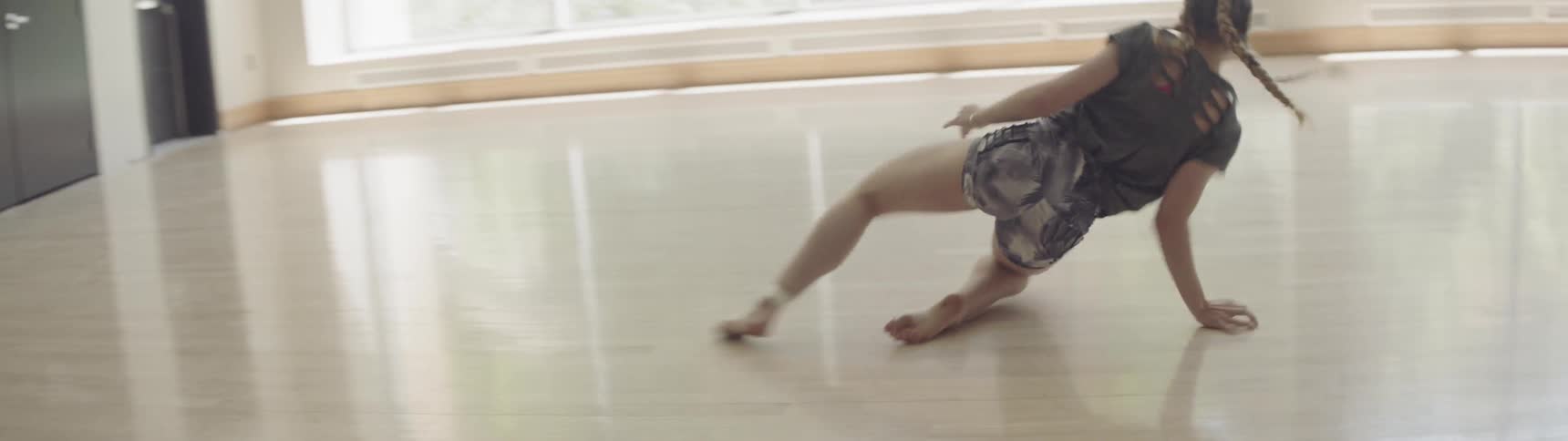 A woman is spinning and dancing in the hall