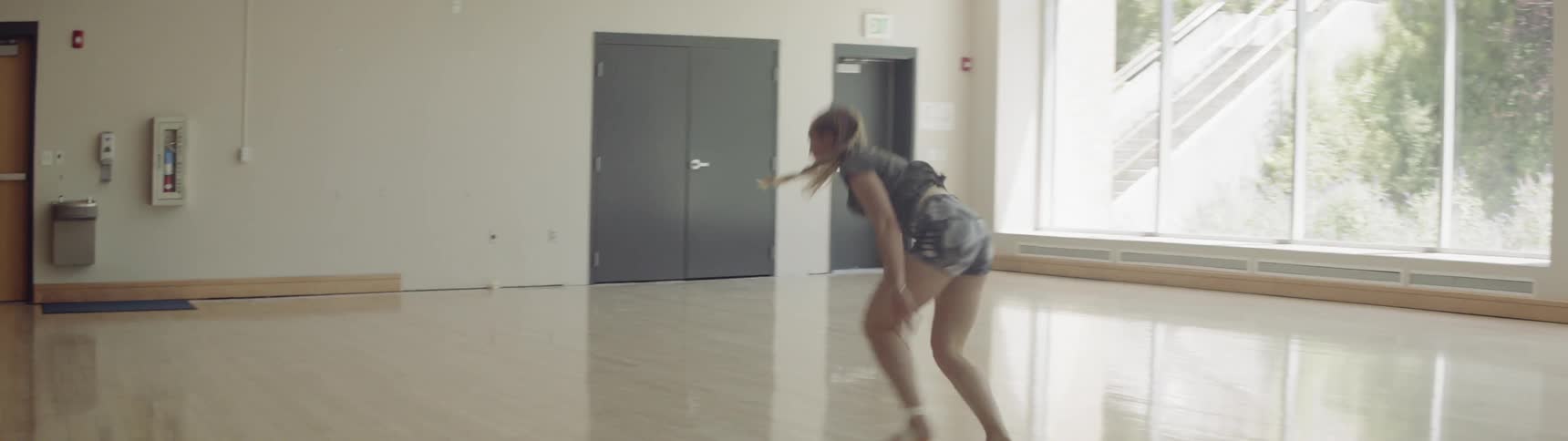 Young dancer practices in an empty room