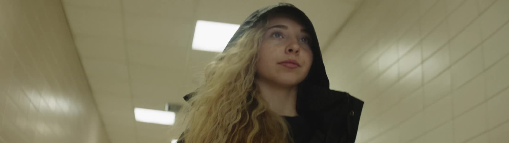 A woman is walking in a hallway