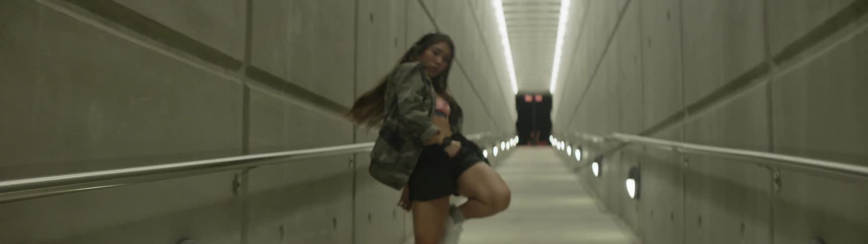 A woman is dancing indoors
