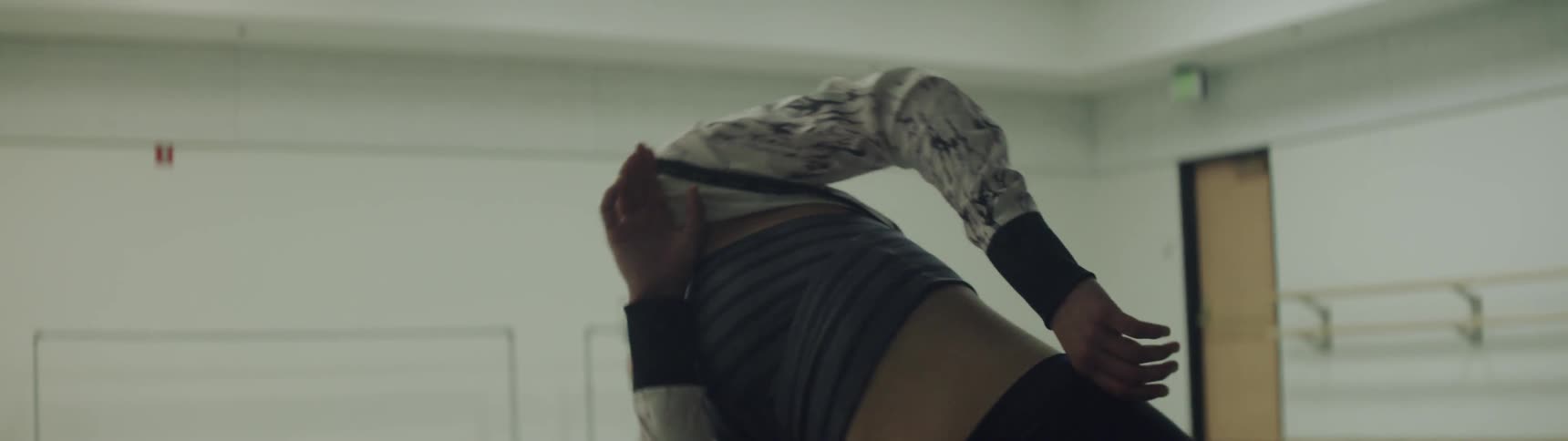 A woman in a dance studio dancing