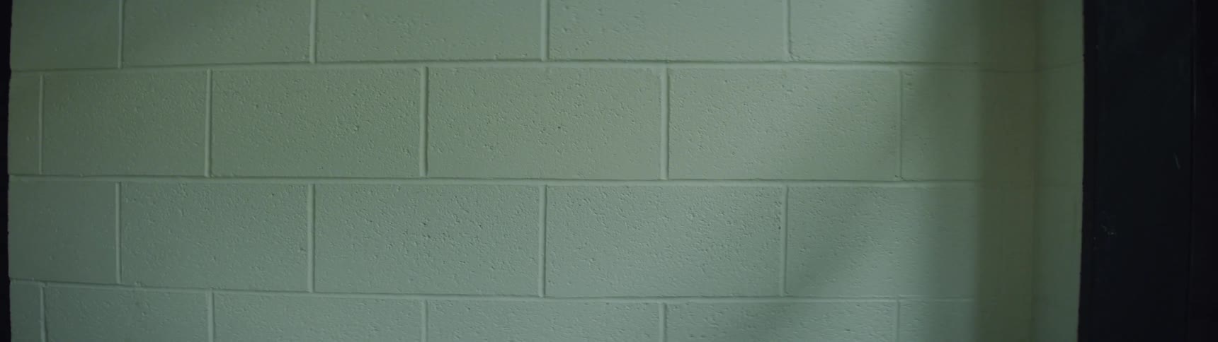 Light and shadows on white cinder block wall
