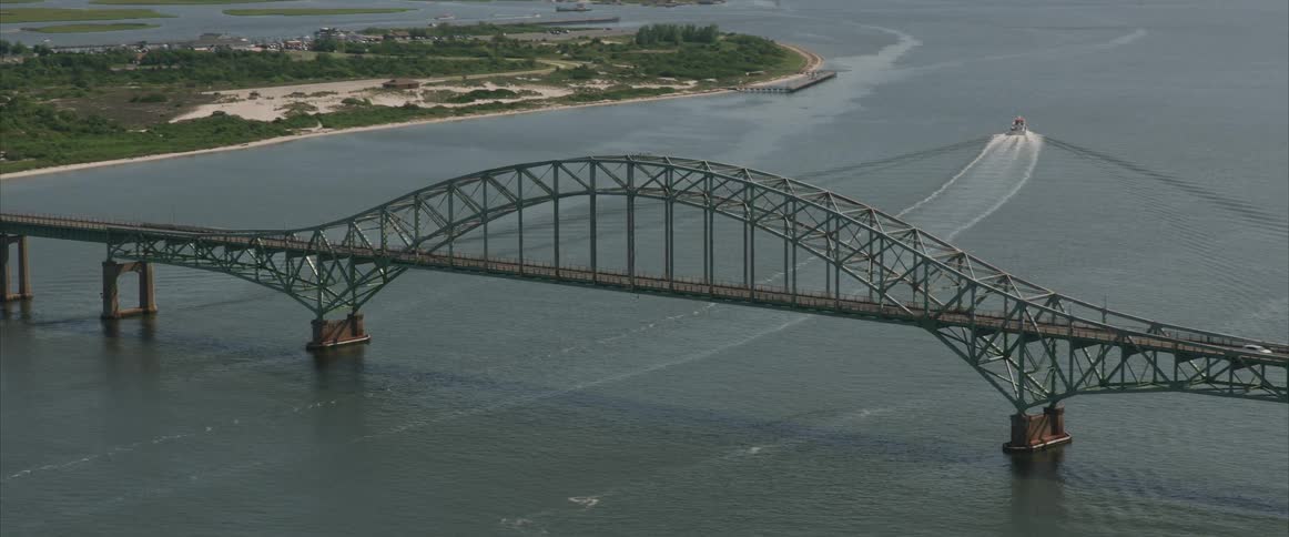 Cars travel over the large bridge