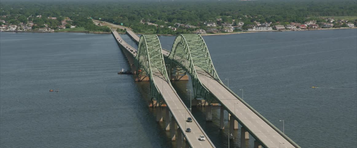 Vehicles traveling over a long bridge