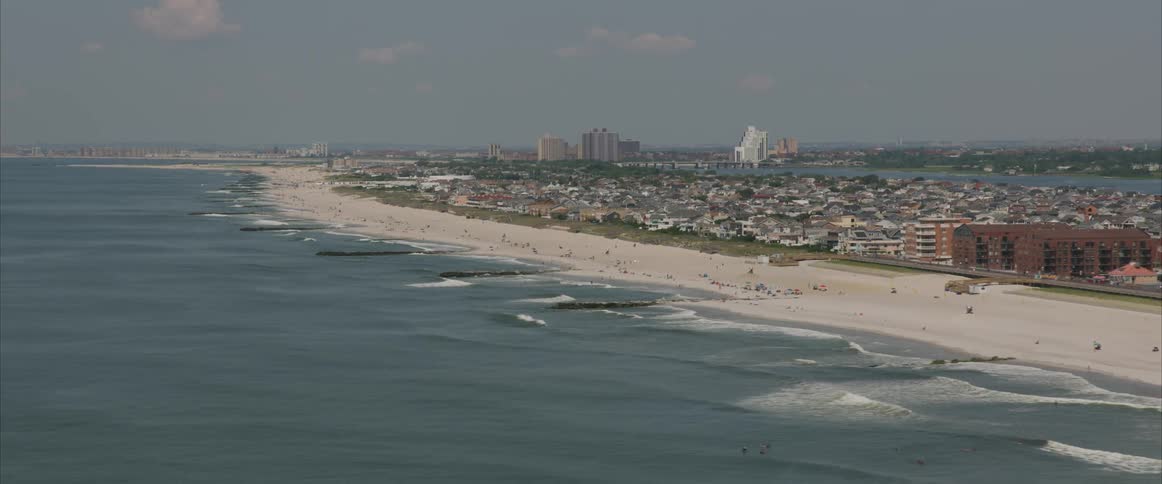 Skyline view of the water and beach with the city in the background