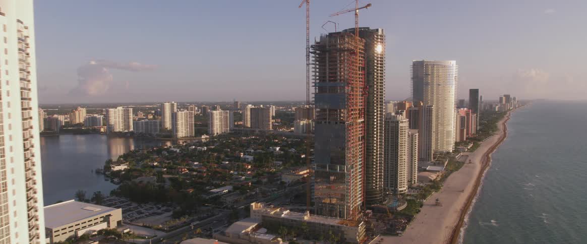 Skyscrapers bordered by ocean and beach