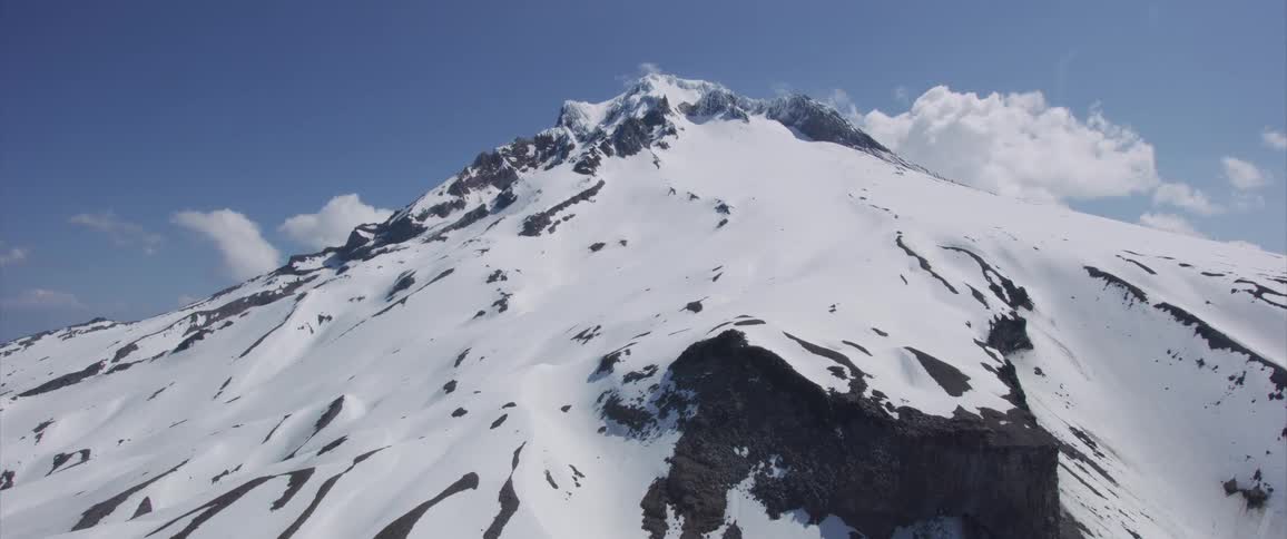 Skyline of the snowy mountain slope with blue sky during daylight