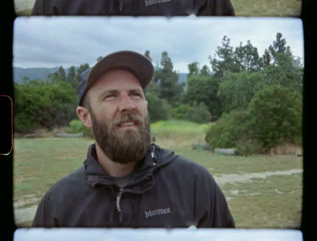Man in baseball cap gazes at sky
