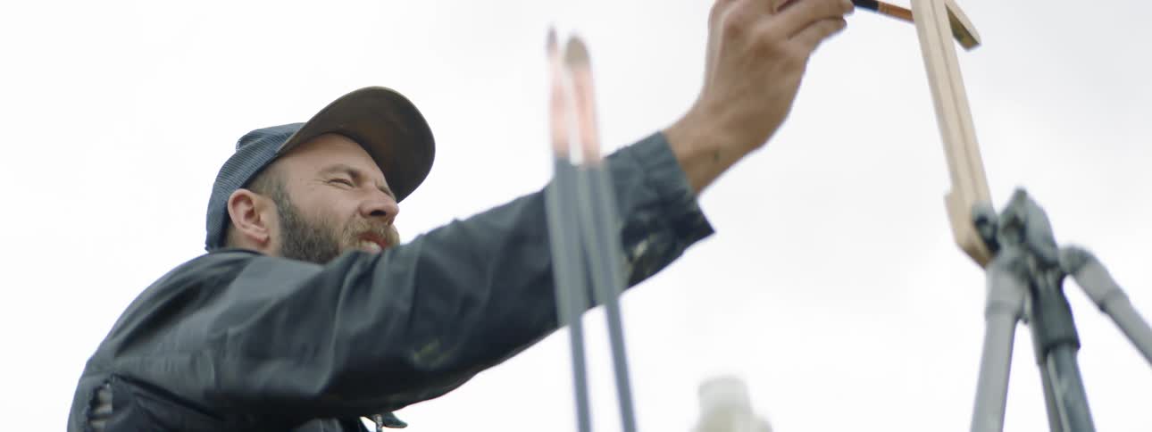 A man painting a cross