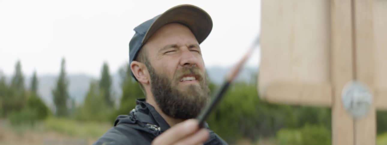A man paints outside