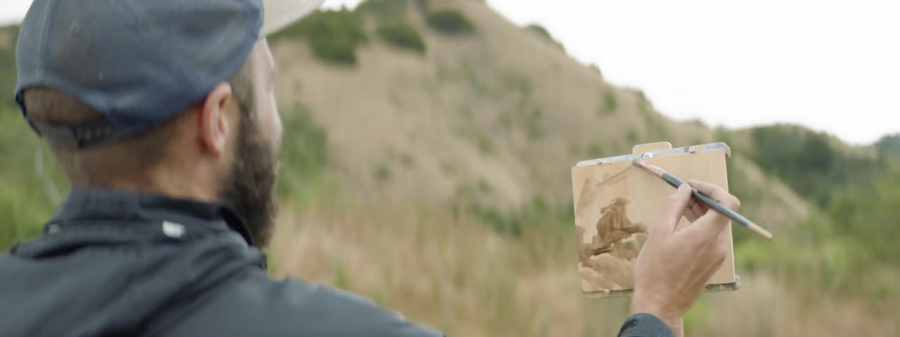 Man paints mountain