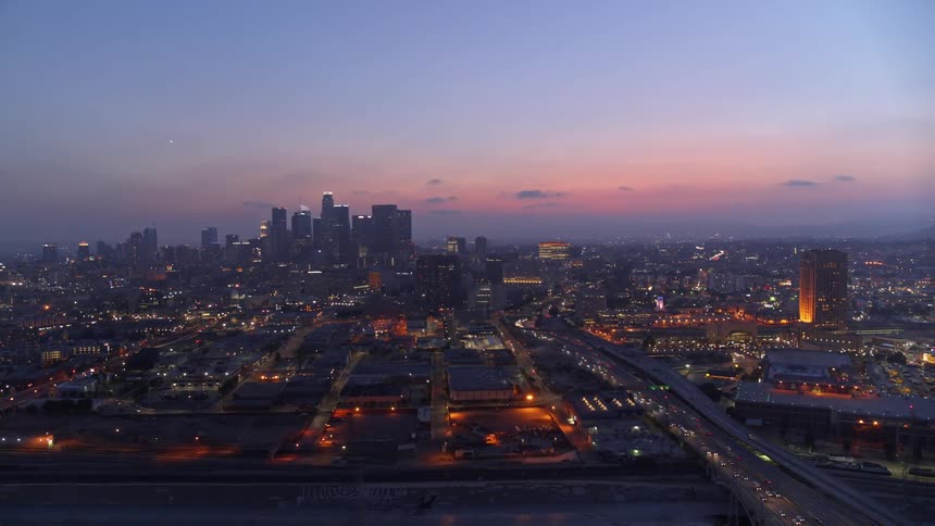 A city skyline glows at dusk
