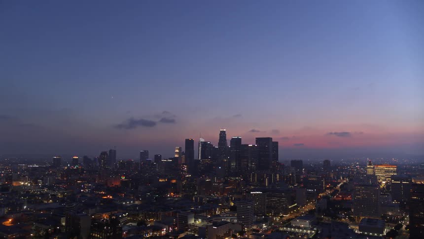 Skyline of the illuminated city with skyscrapers at dusk
