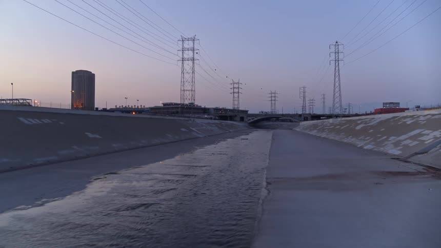 A cement flood control channel in the evening