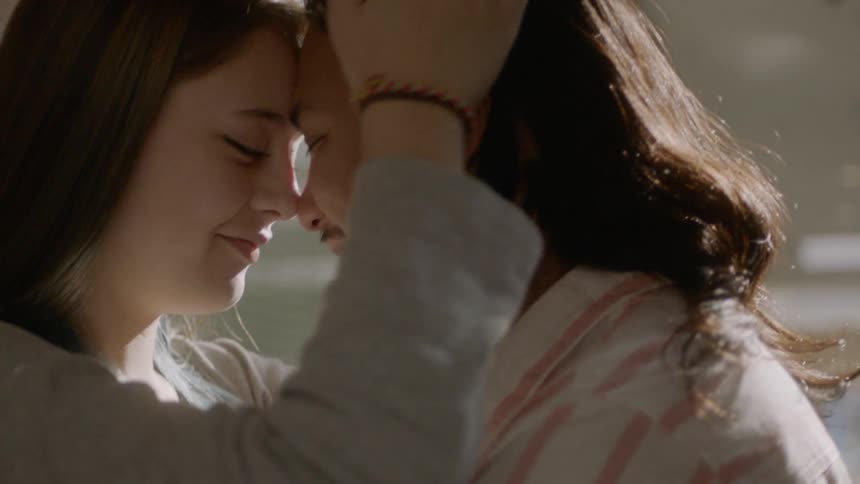 A couple lean on each other's forehead closely