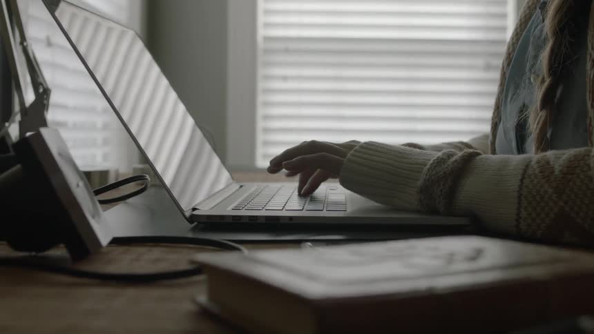 A person typing at a computer