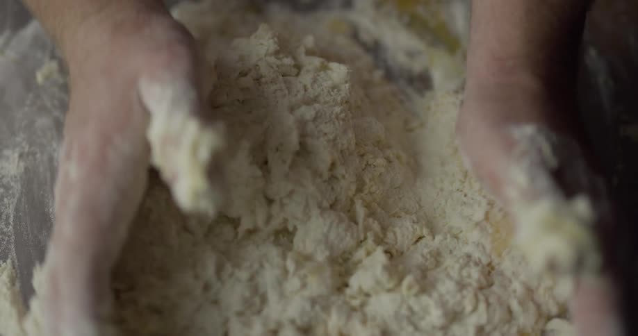 Mans hands mixing flour and eggs