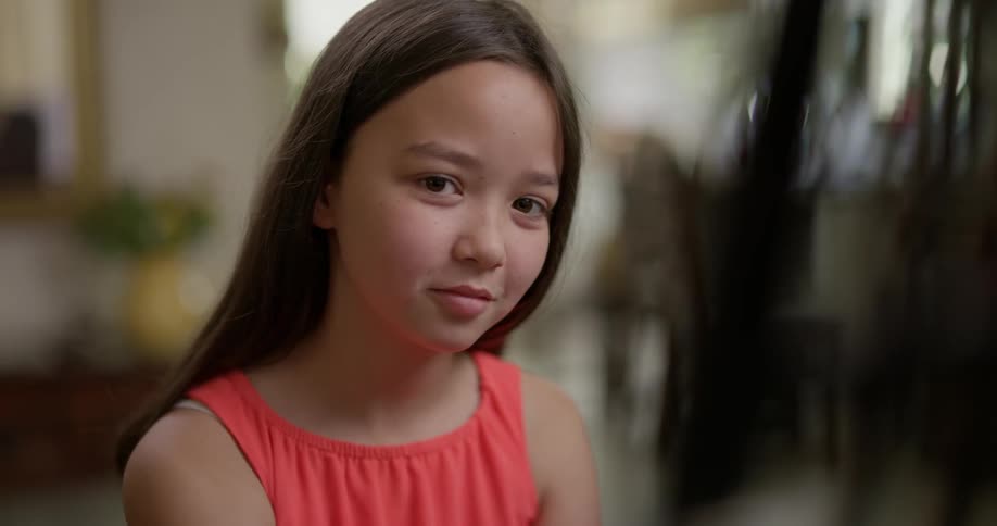 A young girl looks at the camera