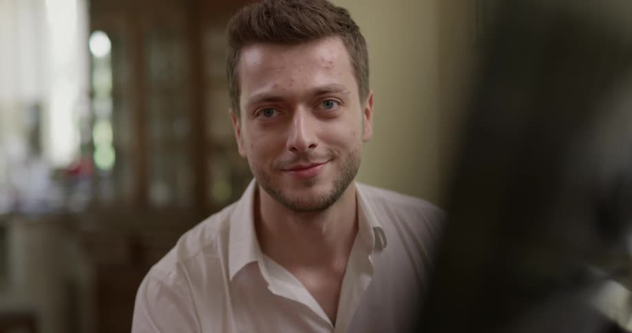 Man smiles and looks into the camera