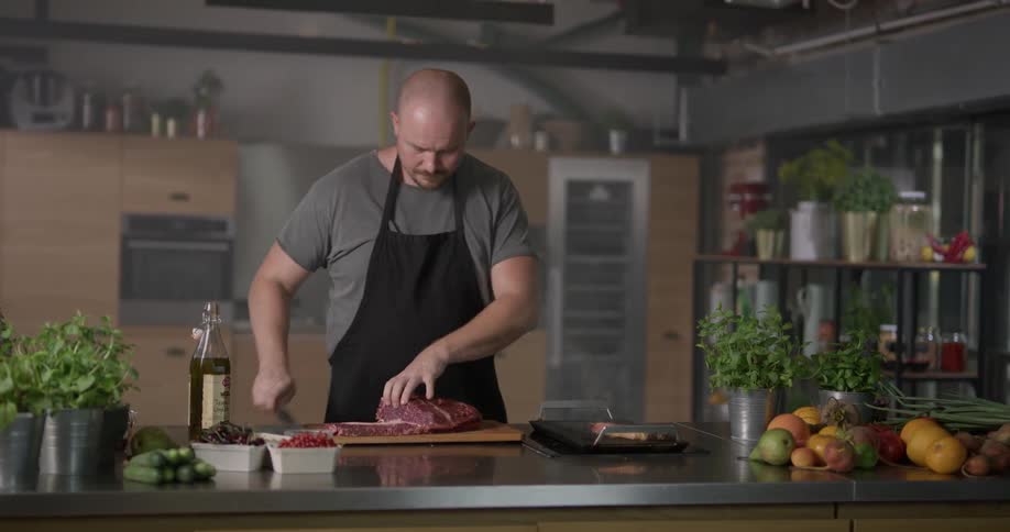 Man slicing meat and pouring oil on it
