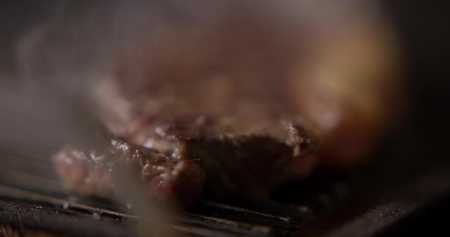 Beef being cooked over a grill