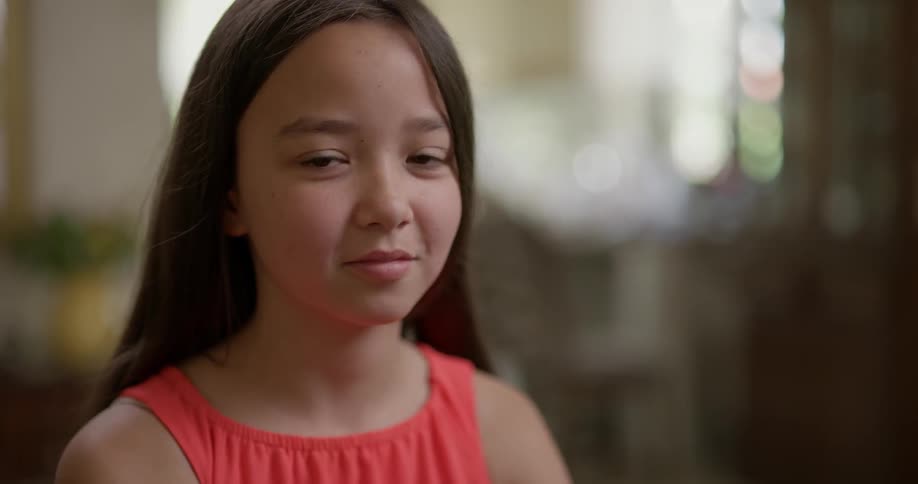 Girl looks up with slight smile