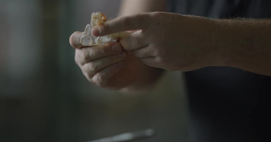 A man opening a shrimp