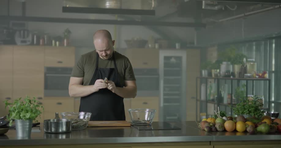 A man twists and peels a vegetable