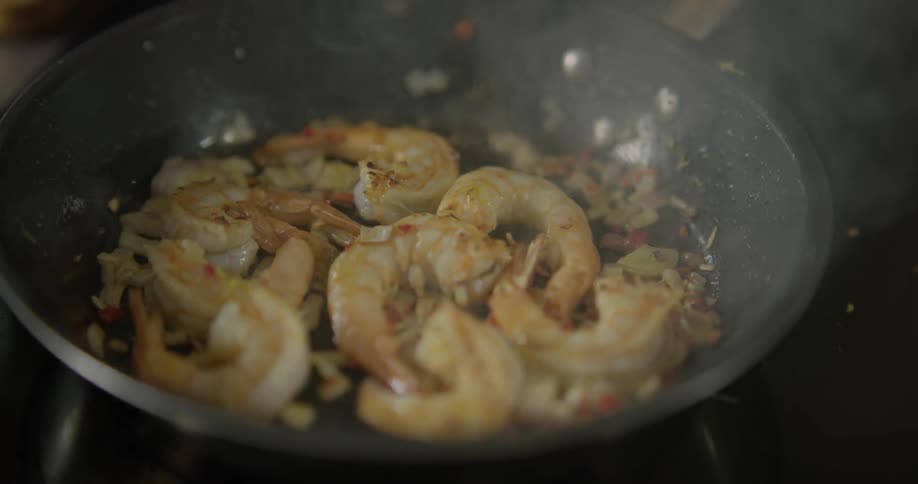 Steaming shrimp being fried in a skillet