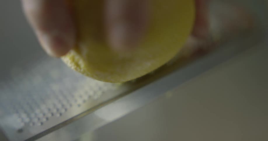 Lemon is rubbed against a grater