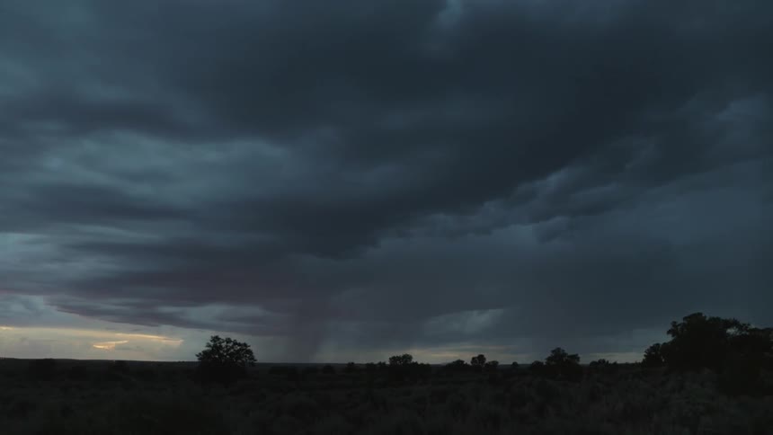 Storming and lightning in a rural area at sunset