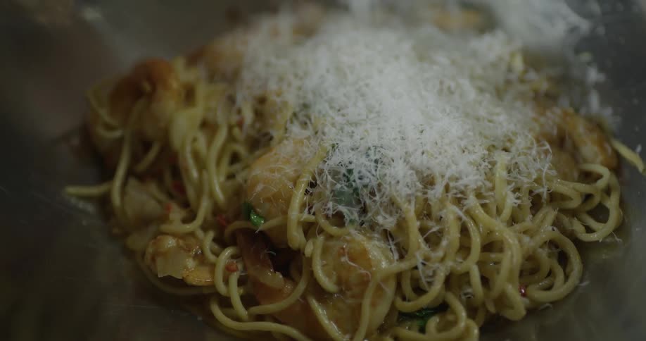 Adding grated cheese to pasta