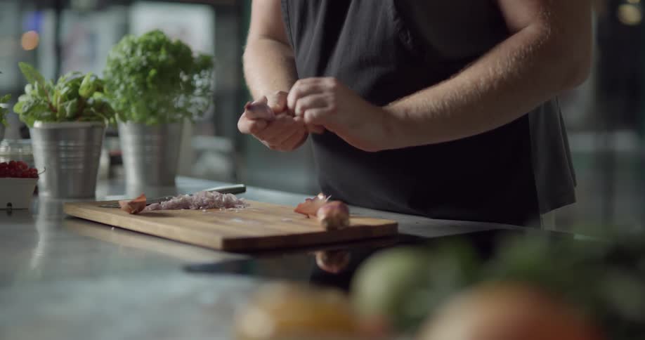 A man cutting vegetables and peeling them