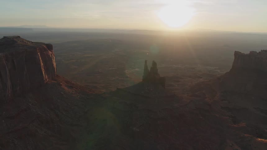 The sun rises over a canyon