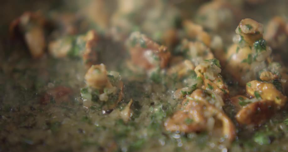 The camera looks a food cooking in a pan