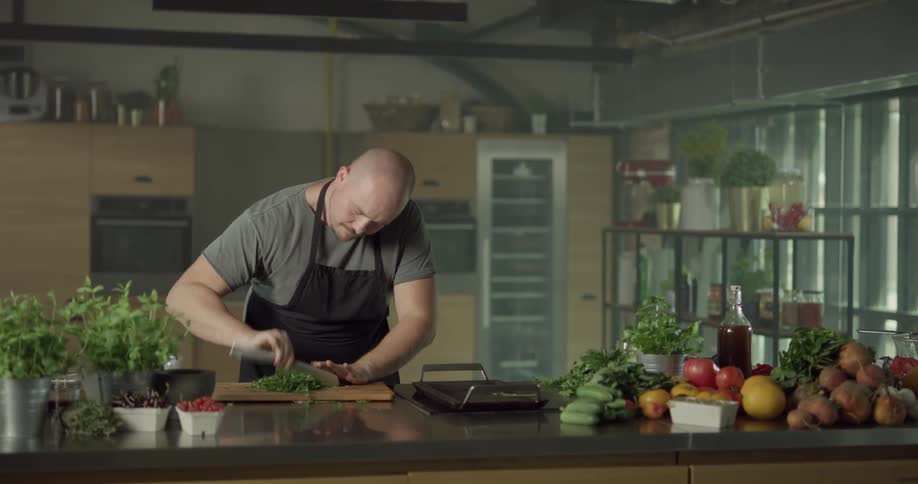 A man chopping vegetables on a cutting board
