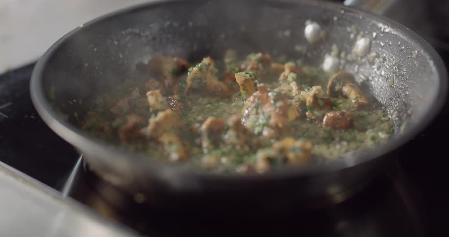Mushrooms being cooked on a frying pan