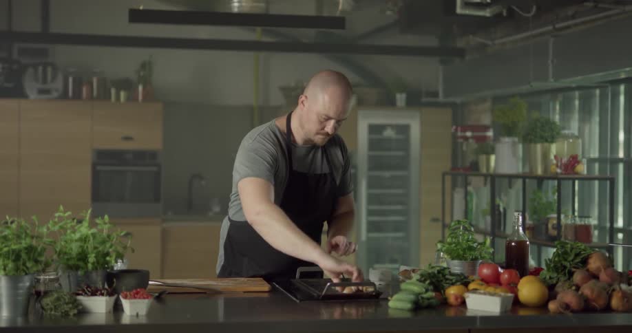 A chef prepares food on a griddle