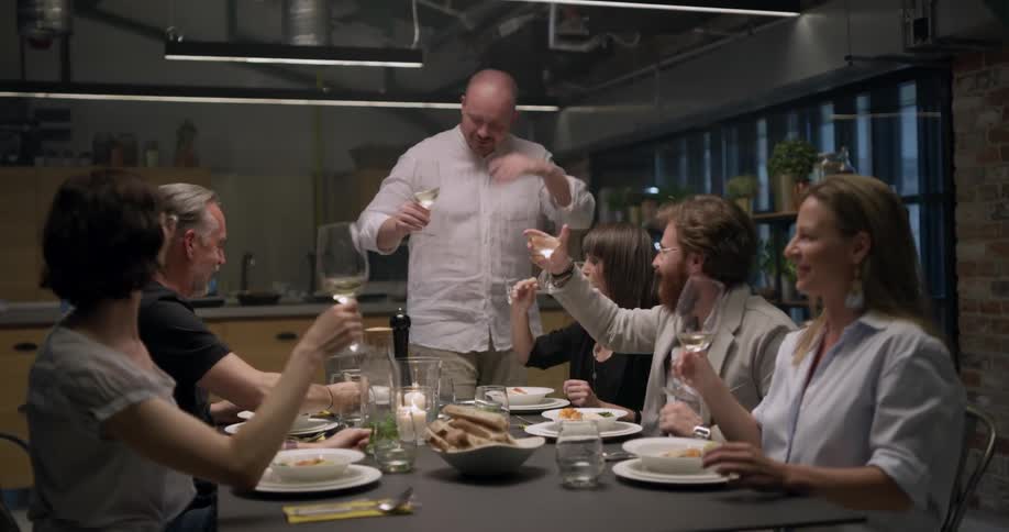 Group of friend toasting with wine before dinner