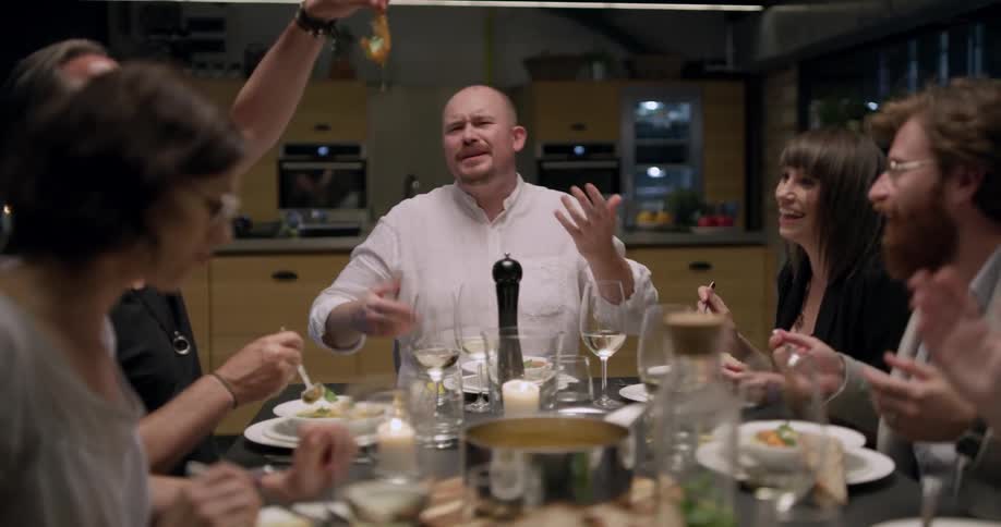 Group of friends having a lively chat at dinner