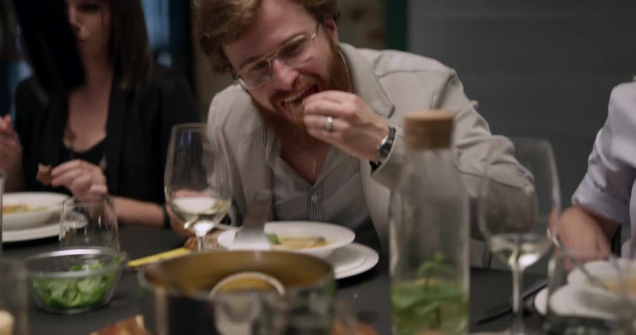 Group of friends having a lively chat over dinner