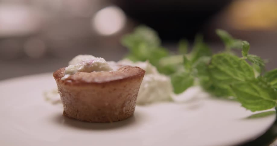Spooning whipped cream onto a dessert