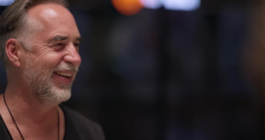 A man at a table sitting and talking