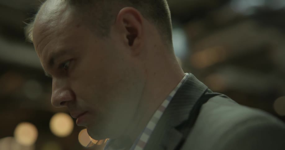 A man is standing looking around