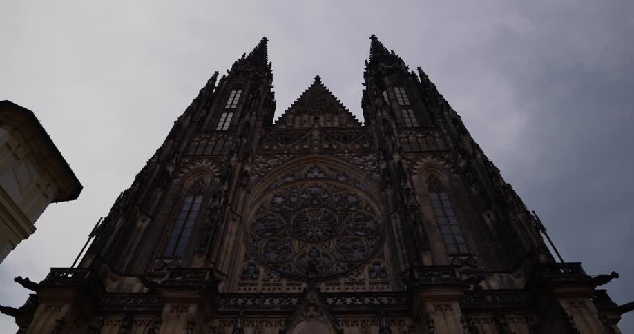 A cathedral with the sky and clouds in the background