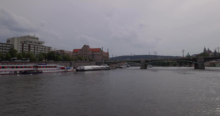 Bridge spans river next to ships