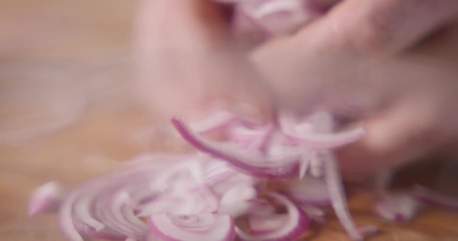 Cook picks up sliced onions