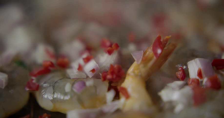 Shrimp being cooked with chopped vegetables