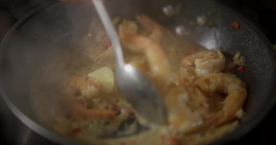 Shrimp is being stirred in the pan